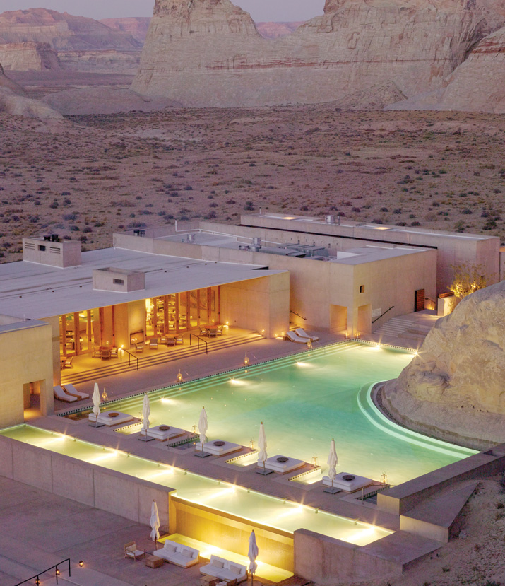 Amangiri cliff-edge pool at dusk — loungers lining the deck
